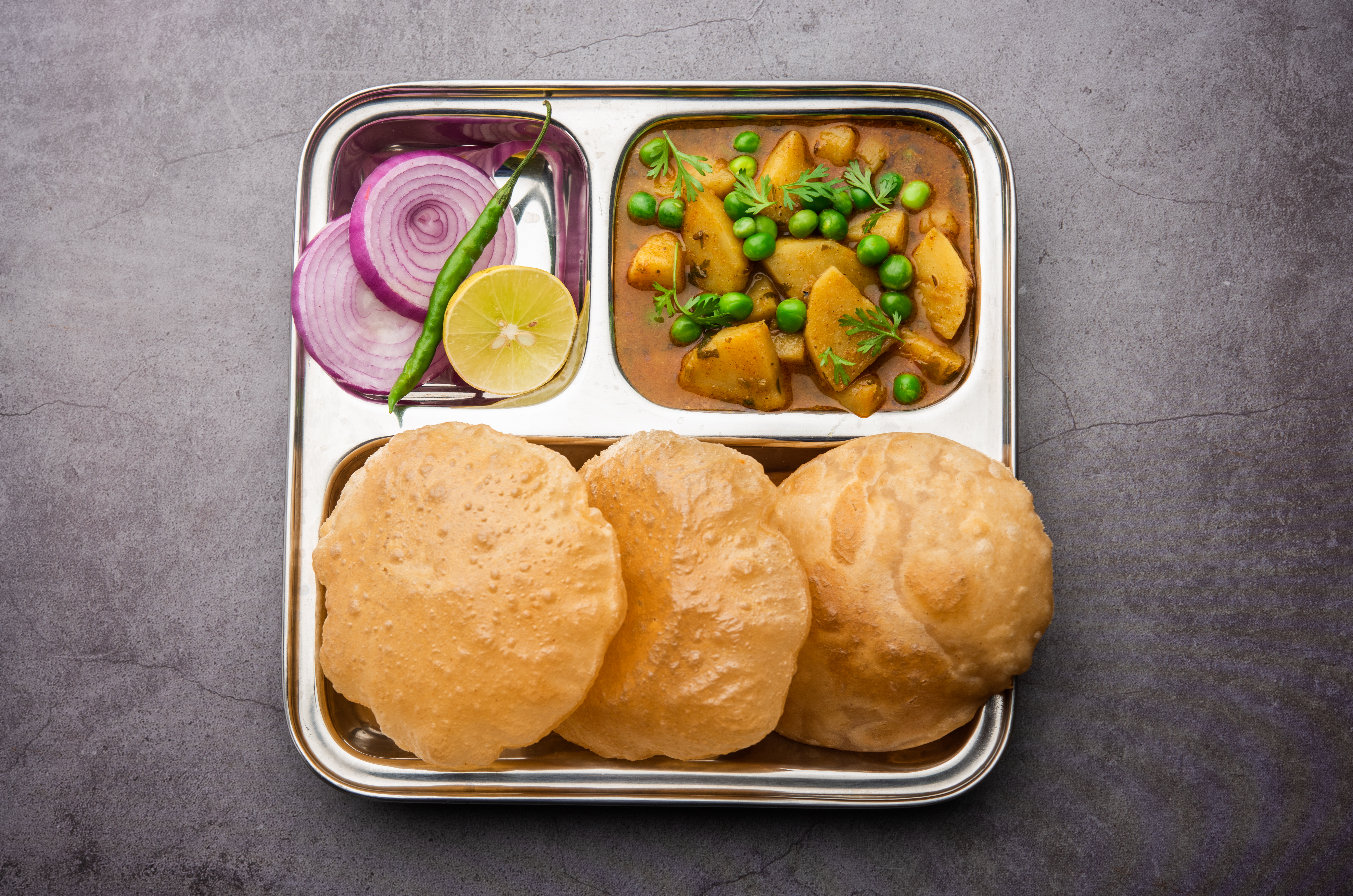 Fried bread with spiced potato curry (2 Pcs + Sabji)